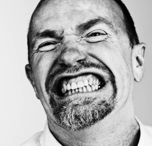istock Furious mature man grimaces and snarls 851475068