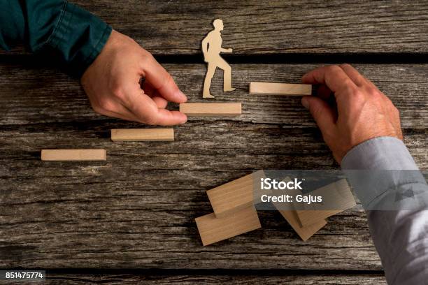 Two People Building Small Toy Wood Staircase Stock Photo - Download Image Now - Ladder of Success, New Business, A Helping Hand