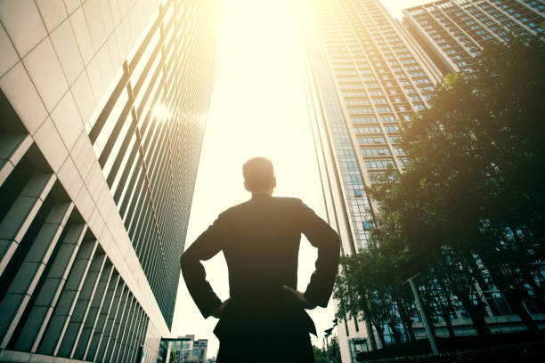 Businessman standing between city buildings