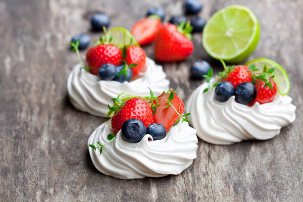 A delightful display of gluten-free mini meringues in a Prague café, showcasing a variety of pink and white swirls. This tempting treat captures the essence of indulgence and the joy of discovering local delicacies during a staycation.