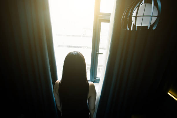 istock young woman open the curtains 851478990