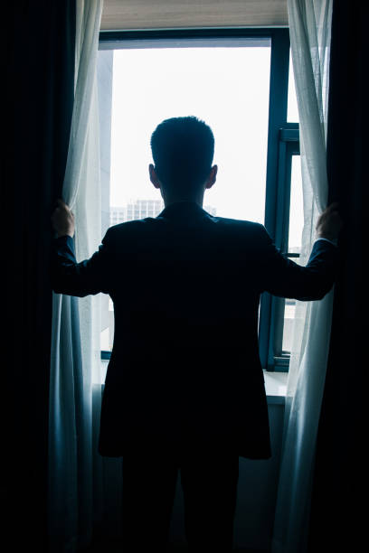 istock Businessman open curtains in the morning 851479094