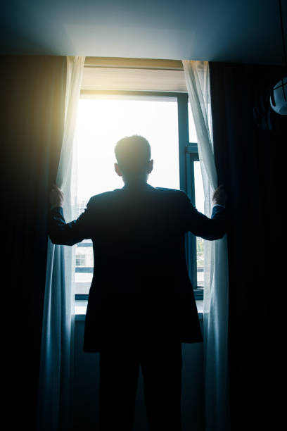 istock Businessman open curtains in the morning 851479178