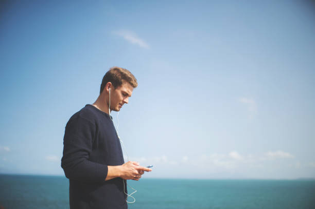 istock Student Browsing Music on his mobile phone 851483502