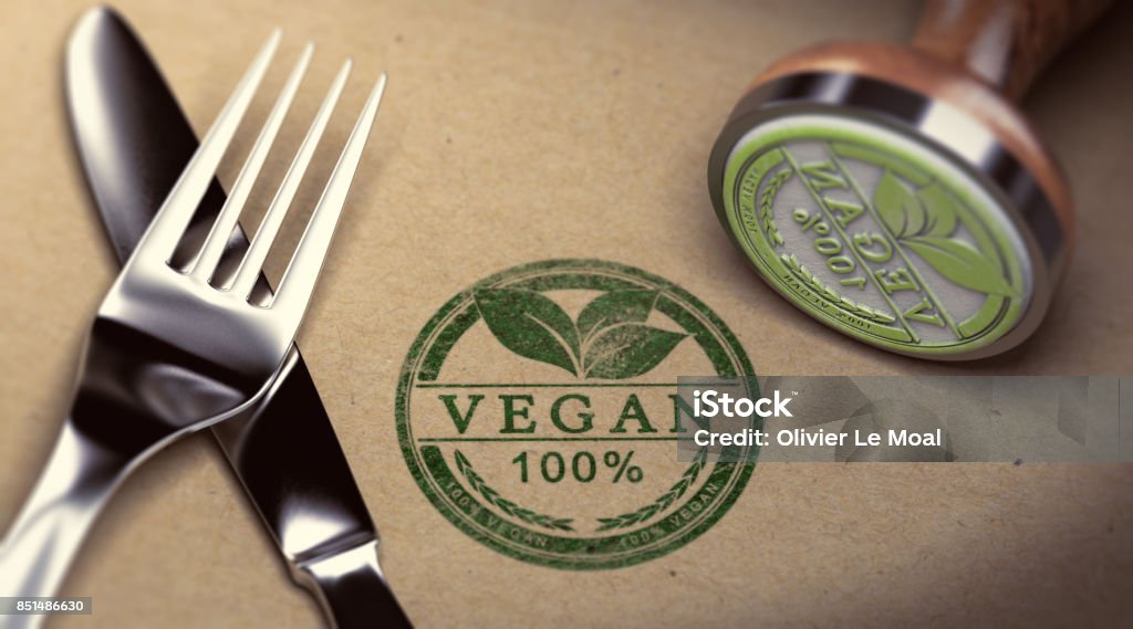 Vegan Restaurant Fork, knife and rubber stamp with the text vegan stamped over cardboard background. Concept of restaurant. 3D illustration. Vegan Food Stock Photo