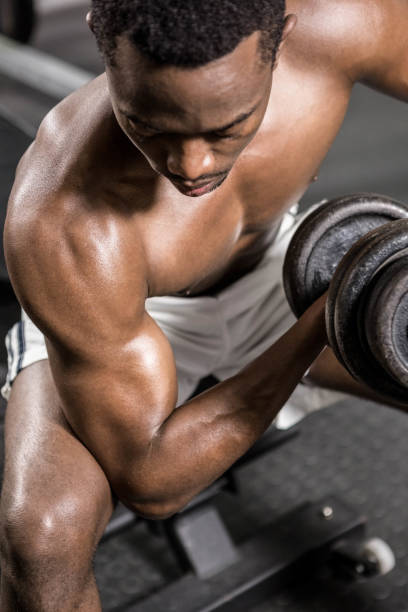 istock Shirtless man lifting dumbbell on bench 851496870