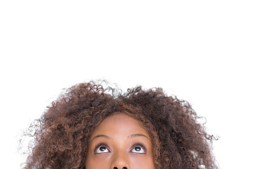 Attractive woman looking up on white background