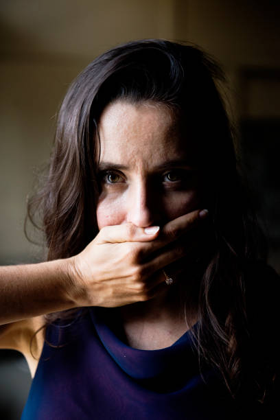 istock Woman with hand covered over her mouth 851498450