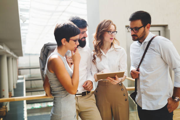 istock Group of young perspective businesspeople having discussion 851498820