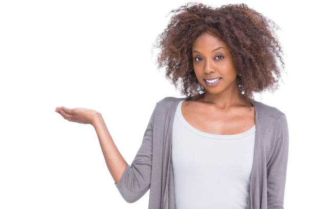 istock Attractive brunette holding hand out as a presentation 851501516