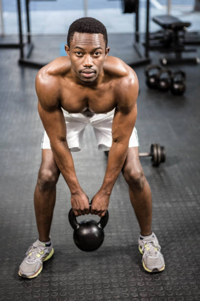 istock Shirtless man lifting heavy kettlebell 851502206