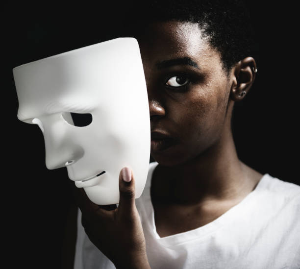 Black woman holding white mask