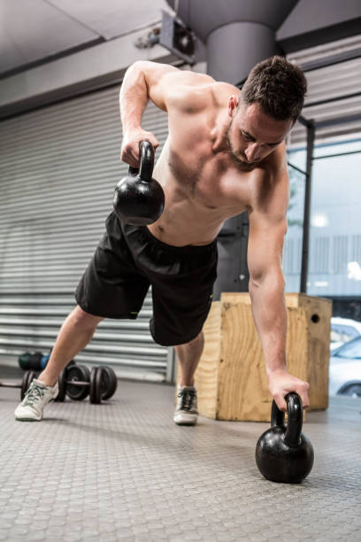 istock Shirtless man doing push up with kettlebells 851540324