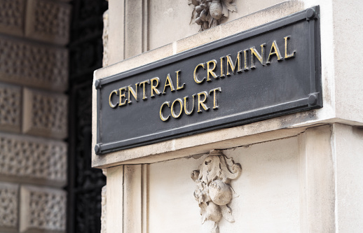 A sign outside an entrance to the Central Criminal Court, often called the Old Bailey because of the street it is located on in the City of London.  Major criminal cases are dealt with at this court.