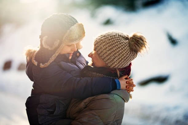 istock Mother and son embracing on a sunny winter morning 851549100