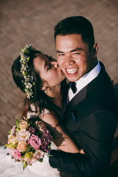istock Sweet wedding couple hugging on the waterfront 851552550