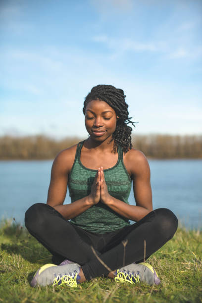 istock African American woman doing yoga outside by river 851557772
