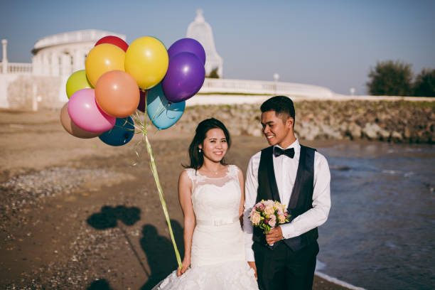 istock Wedding couple with balls walking along the seashore 851557820