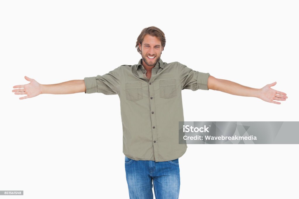 Smiling man with arms open wide Smiling man with arms open wide on white background Arms Outstretched Stock Photo