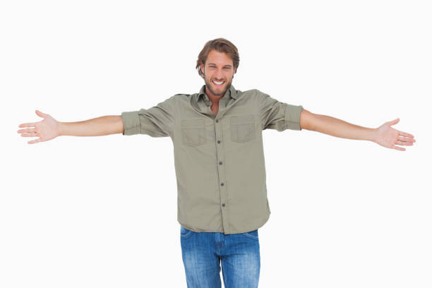 Smiling man with arms open wide Smiling man with arms open wide on white background arms outstretched stock pictures, royalty-free photos & images
