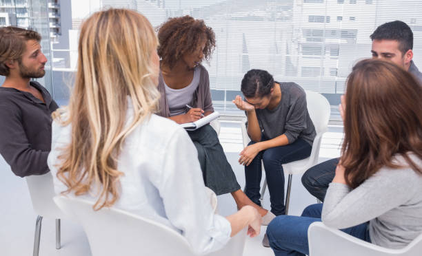 istock Group therapy session with one woman crying 851565526
