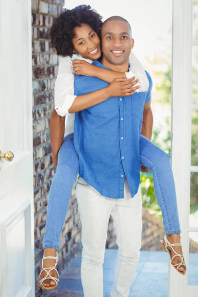 istock Handsome man giving piggy back to his girlfriend 851565582
