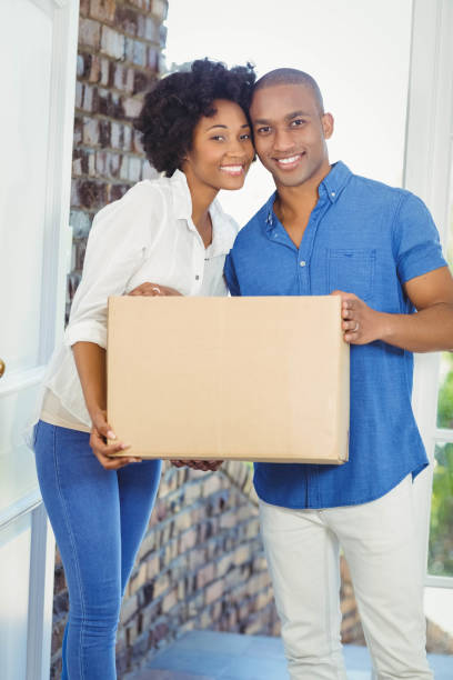istock Happy couple holding box 851565774
