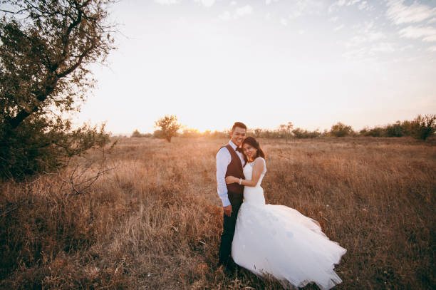 istock Wedding couple strolling in a valley with dry grass 851566602