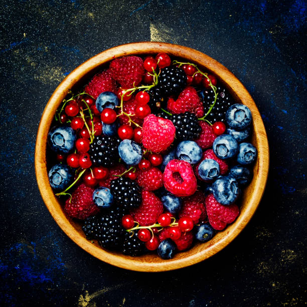istock Summer berries in wooden bowl 851575484