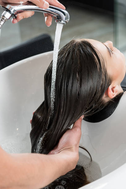 istock woman having hair wash 851579564