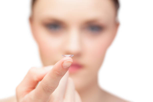 istock Beautiful nude model holding contact lens 851579934