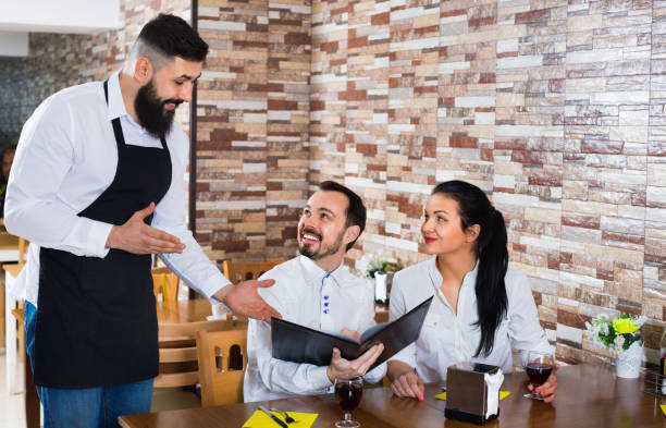 istock Waiter serving rural restaurant guests at table 851580392