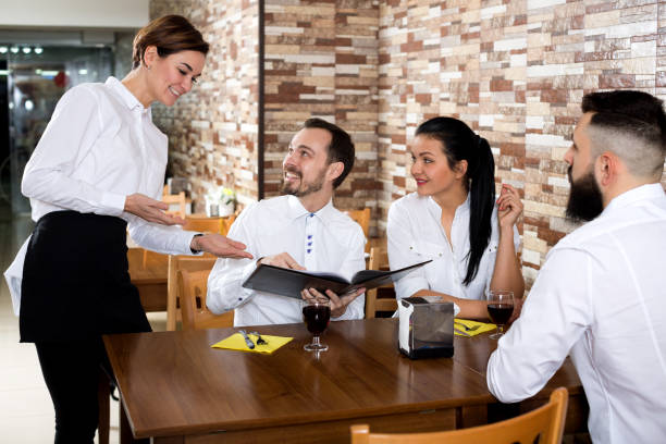 istock Waitress taking order at table of people 851580432