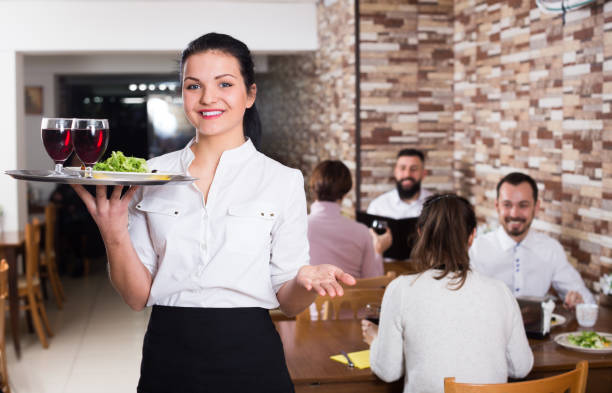 istock Cheerfull female waiter carrying order for visitors 851580500