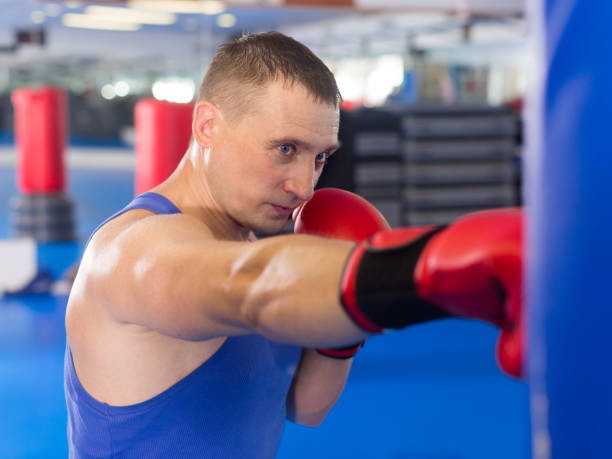 istock Young male is fighting punching bag 851580830