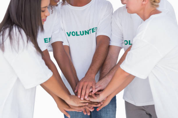 istock Happy volunteers putting hands together 851588770