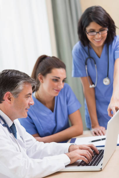 istock Nurses and doctor looking at laptop 851589516