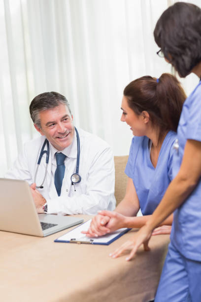 istock Happy nurses chatting with doctor 851589676