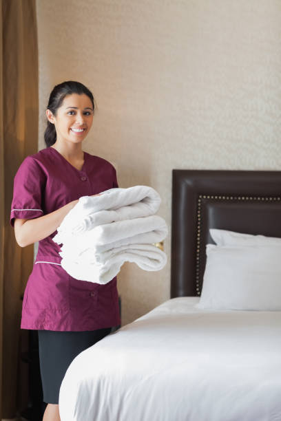 istock Smiling hotel maid holding towels 851590232
