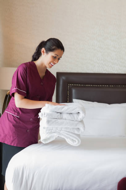istock Hotel maid putting towels on bed 851590270