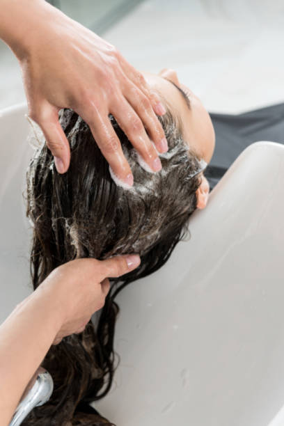 istock woman having hair wash 851591150