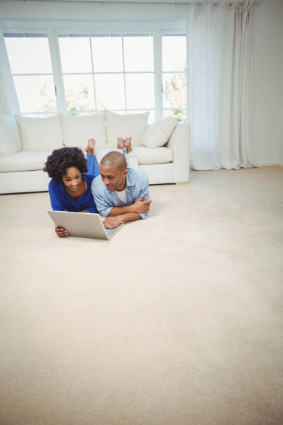 istock Smiling couple lying on the floor 851602464