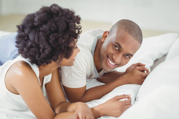 istock Smiling couple lying on the bed 851612976