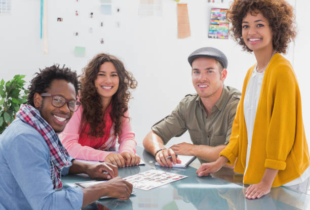 istock Team going over photo contact sheet and smiling at camera 851613814