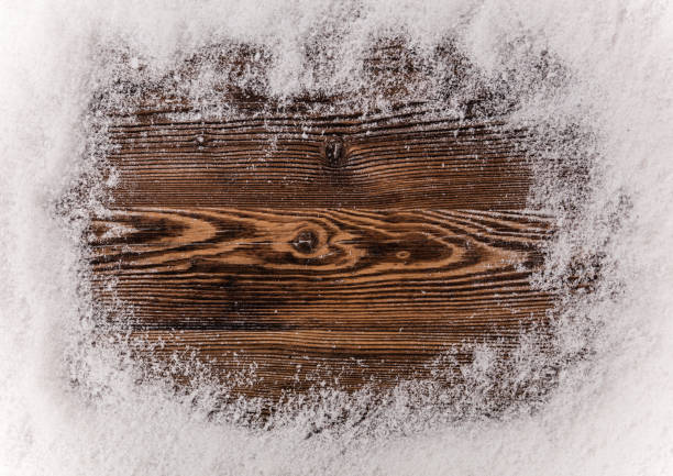 istock Snow flakes on wooden background 851625966