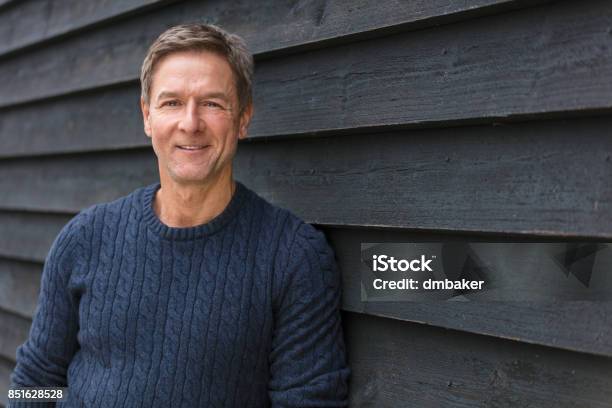 Attractive Successful And Happy Smiling Middle Aged Man Male Outside Wearing A Blue Sweater Stock Photo - Download Image Now