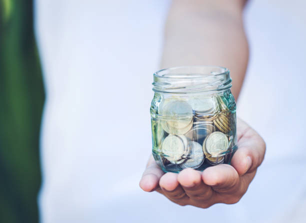 istock money in the glass on hand. 851656164