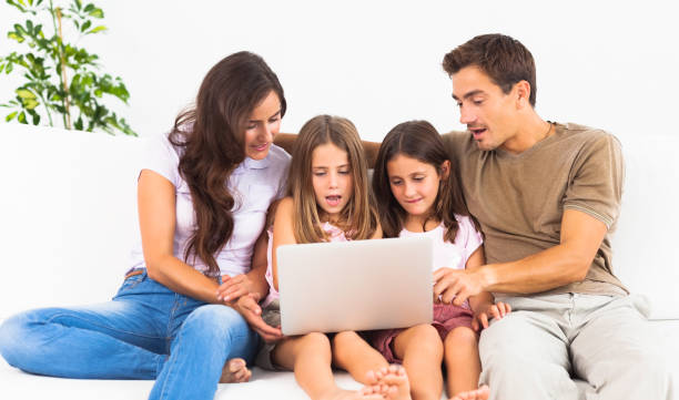 istock Family posing on a sofa with the laptop 851656212