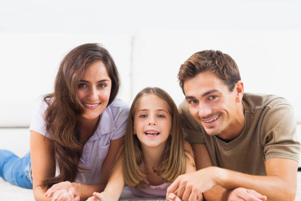 istock Family lying on a carpet 851658326