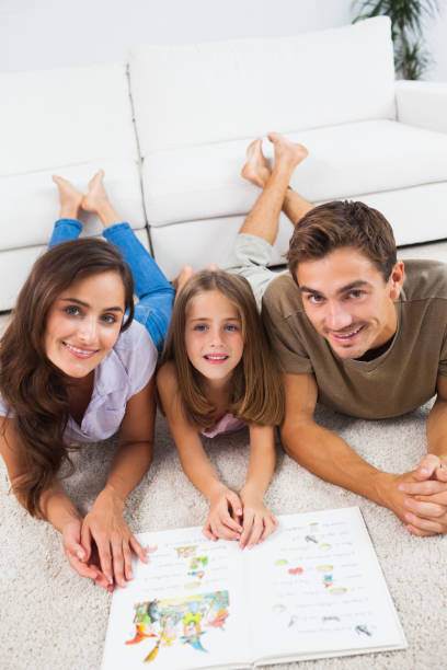 istock Family with a book lying on a carpet 851660634